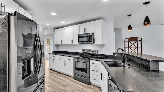 kitchen with light hardwood / wood-style flooring, stainless steel appliances, sink, decorative light fixtures, and white cabinetry