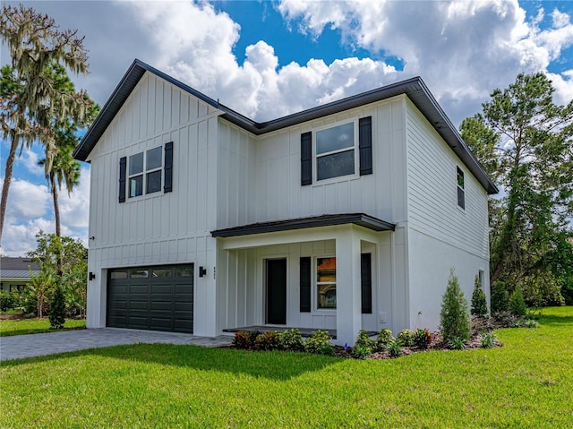 modern farmhouse style home featuring a garage and a front yard