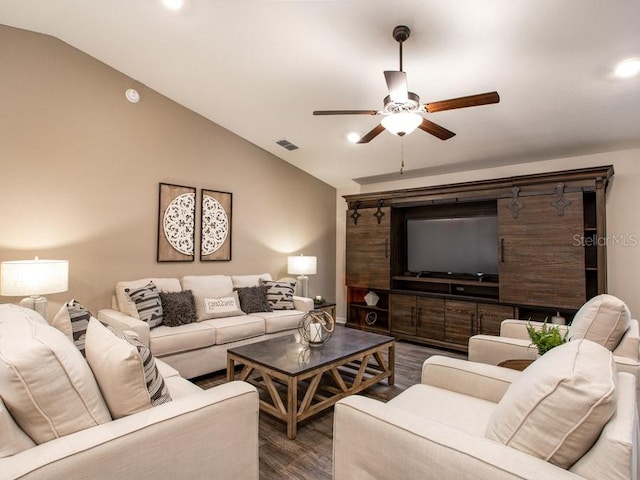 living room featuring ceiling fan, lofted ceiling, and dark wood-type flooring