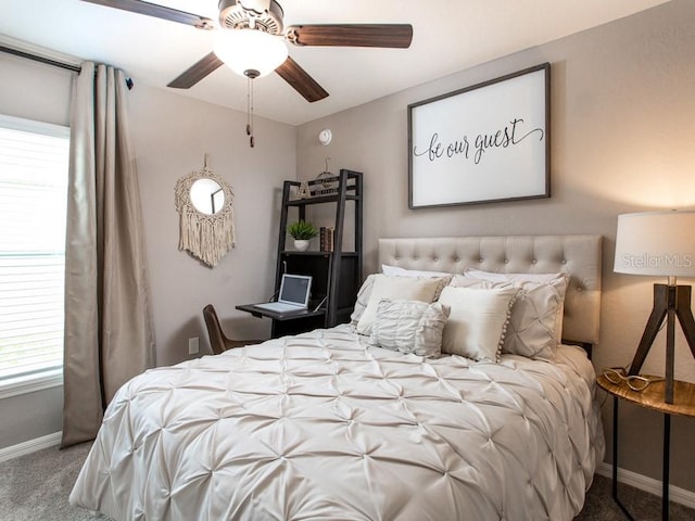 carpeted bedroom with multiple windows and ceiling fan