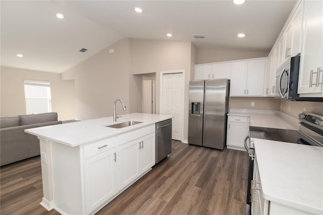 kitchen featuring vaulted ceiling, visible vents, appliances with stainless steel finishes, and a sink