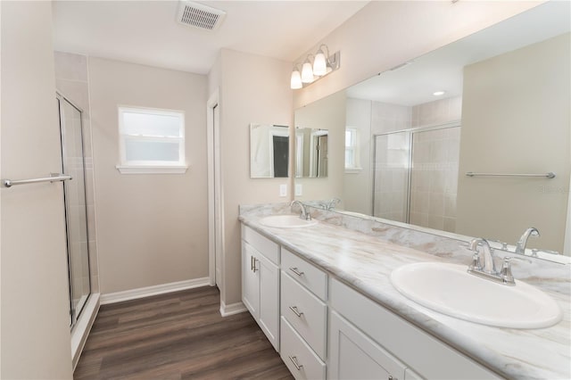 bathroom featuring a sink, visible vents, baseboards, and a stall shower