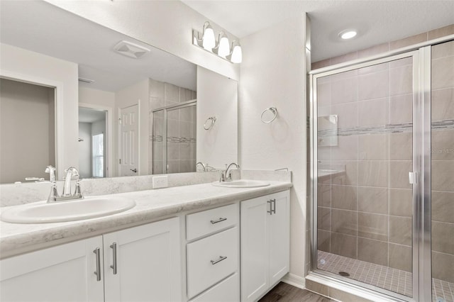 bathroom with walk in shower and vanity