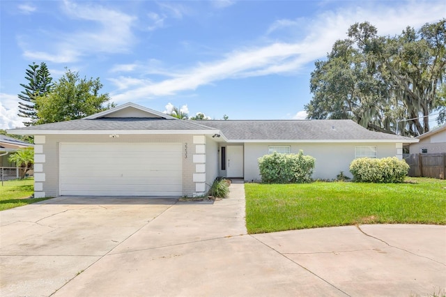 single story home with a front yard and a garage