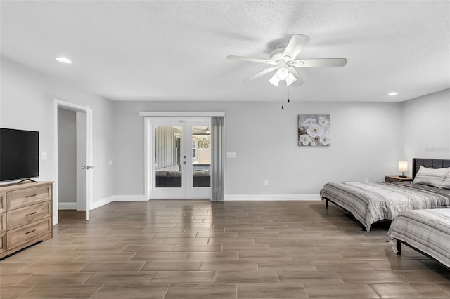 bedroom with access to exterior, a textured ceiling, ceiling fan, french doors, and hardwood / wood-style flooring