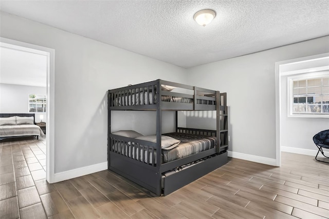 bedroom featuring wood-type flooring and a textured ceiling