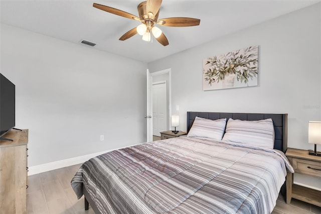 bedroom with ceiling fan and hardwood / wood-style flooring