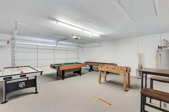 rec room with pool table, a textured ceiling, and electric water heater