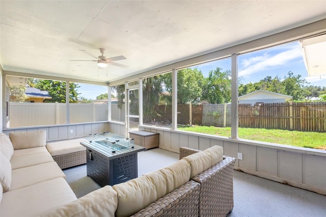 sunroom / solarium featuring ceiling fan and plenty of natural light