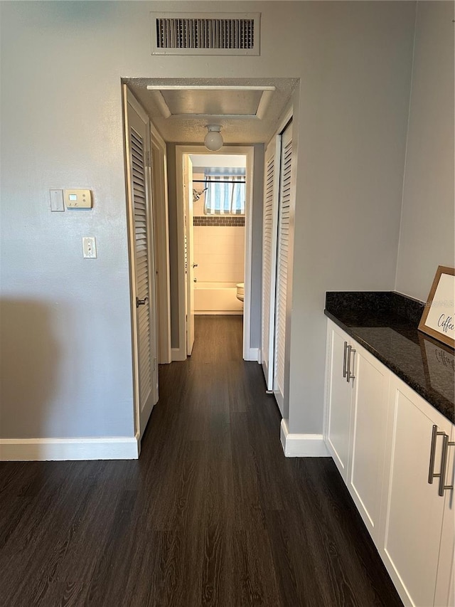 hall with dark hardwood / wood-style floors