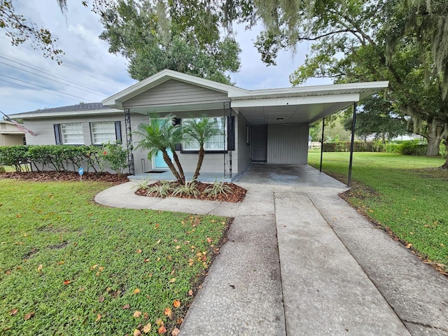 view of front of house with a front lawn and a carport