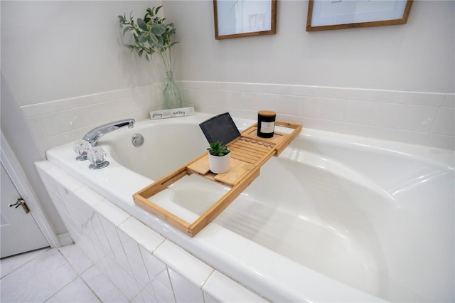 bathroom with a relaxing tiled tub and tile patterned floors