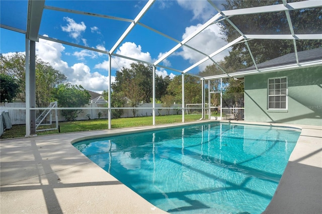 view of swimming pool with a patio area, glass enclosure, and a lawn