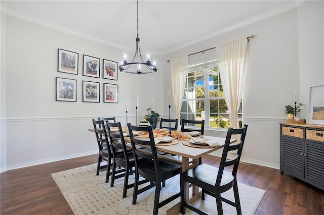 dining room featuring a notable chandelier, ornamental molding, and dark hardwood / wood-style floors