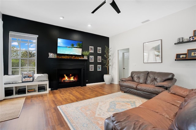 living room with hardwood / wood-style flooring and ceiling fan