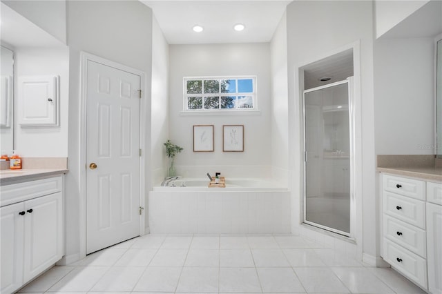 bathroom with vanity, tile patterned floors, and shower with separate bathtub