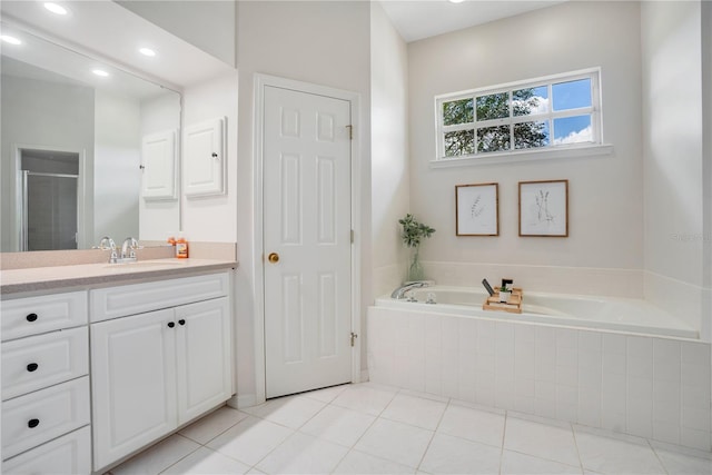 bathroom with tile patterned floors, vanity, and shower with separate bathtub