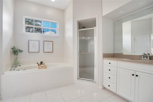 bathroom featuring tile patterned floors, separate shower and tub, and vanity