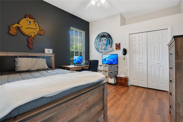 bedroom with hardwood / wood-style floors, a closet, and ceiling fan