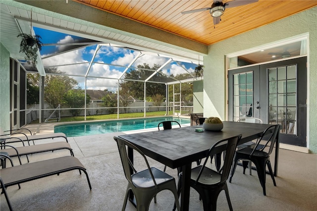 view of pool with french doors, ceiling fan, a lanai, and a patio