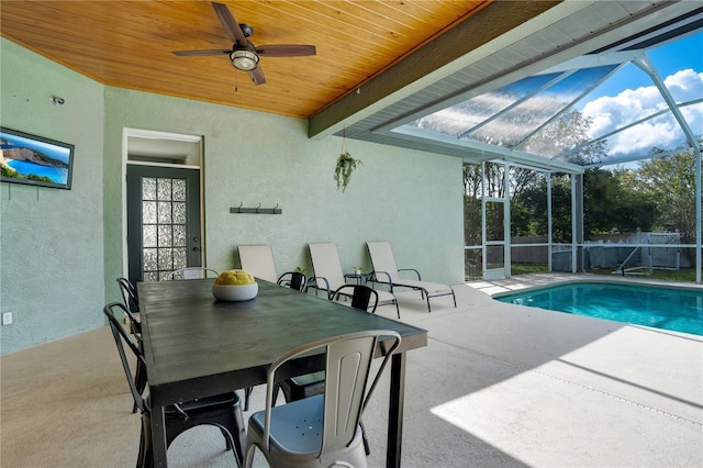 view of pool with ceiling fan, a lanai, and a patio area