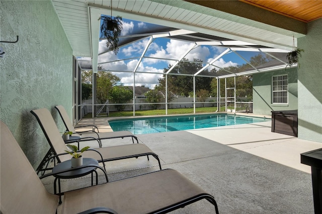 view of swimming pool featuring a lanai and a patio area