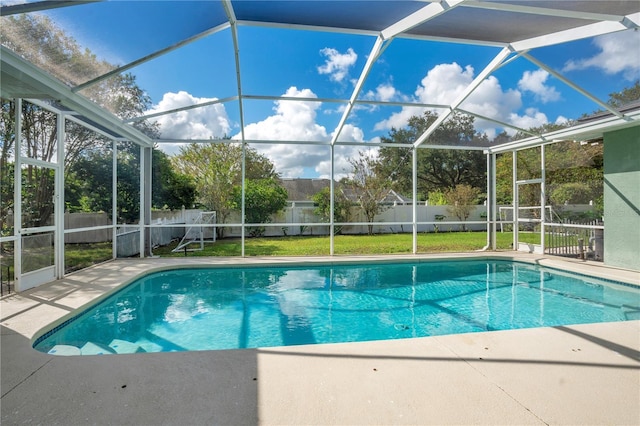 view of pool featuring a lanai and a yard