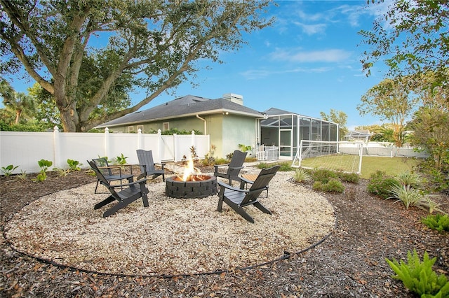 back of house with a lanai and a fire pit