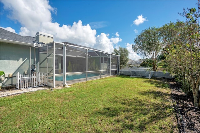 view of yard with a fenced in pool and a lanai