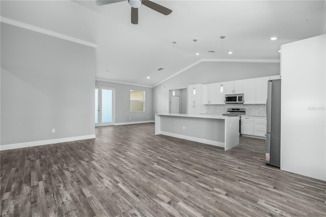 kitchen with a kitchen island, appliances with stainless steel finishes, crown molding, and white cabinets