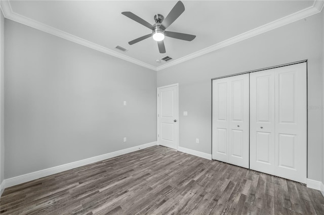 unfurnished bedroom with ornamental molding, hardwood / wood-style floors, and ceiling fan