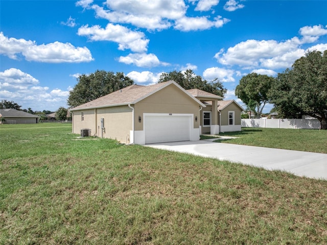 ranch-style house featuring cooling unit, a front yard, and a garage