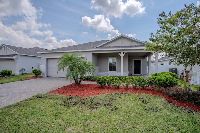 view of front facade featuring a garage and a front lawn