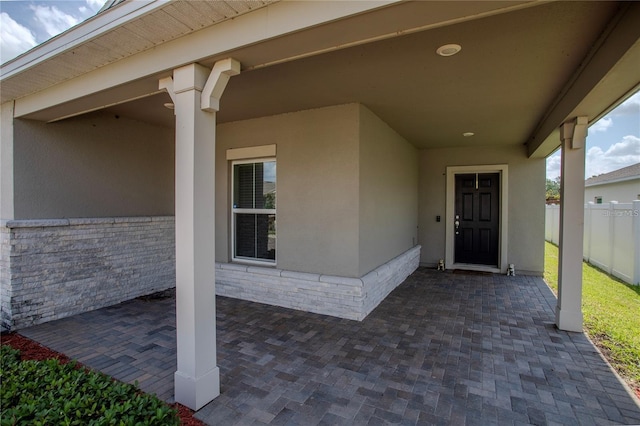 doorway to property with a patio area