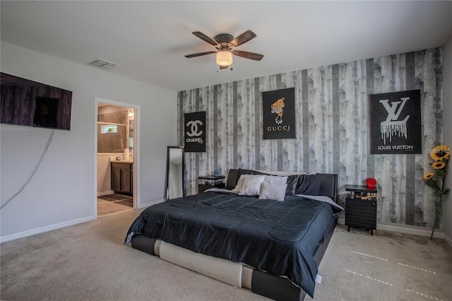 carpeted bedroom featuring ceiling fan and ensuite bathroom