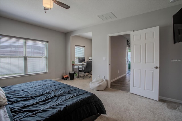 bedroom with a textured ceiling, carpet, and ceiling fan