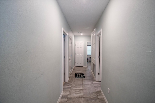 corridor with light tile patterned floors