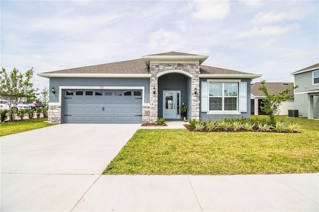 prairie-style house with concrete driveway, stucco siding, stone siding, a front lawn, and an attached garage