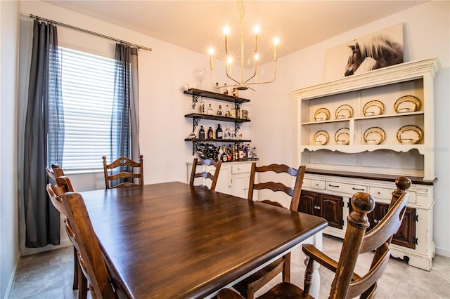 dining space with a chandelier and light tile patterned floors