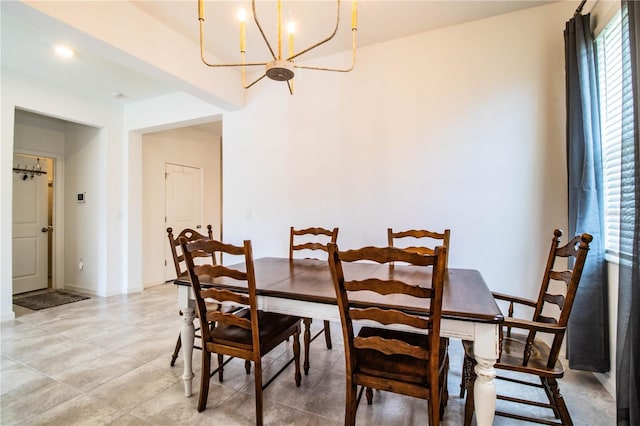 dining area featuring baseboards and an inviting chandelier