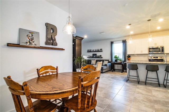 dining area with light tile patterned flooring