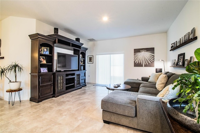 living area with visible vents and light tile patterned flooring