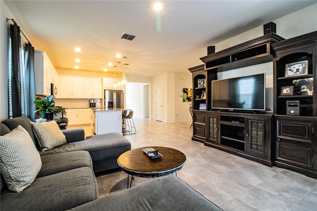 living area with visible vents, recessed lighting, and an inviting chandelier