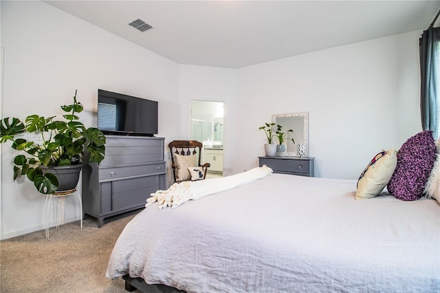 carpeted bedroom featuring visible vents and connected bathroom