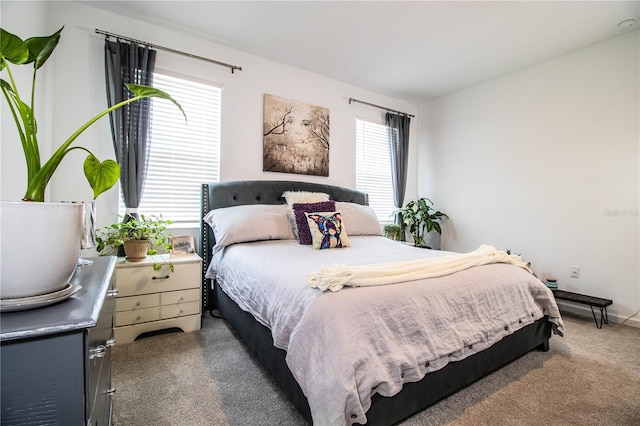 bedroom with dark colored carpet