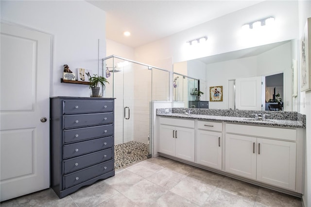 bathroom with vanity and a shower with door