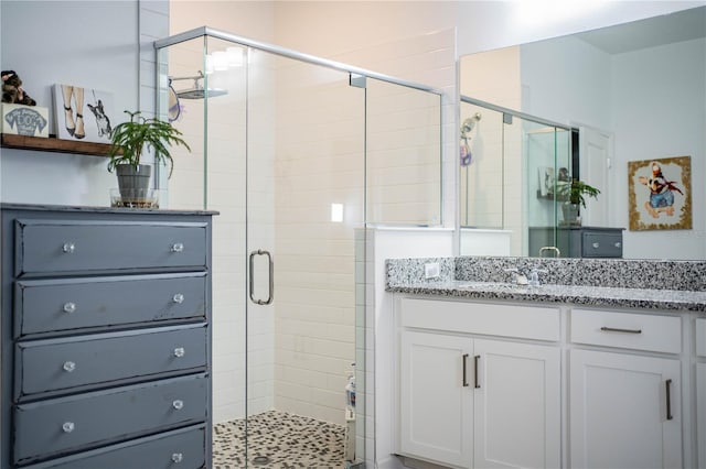 bathroom with a stall shower and vanity