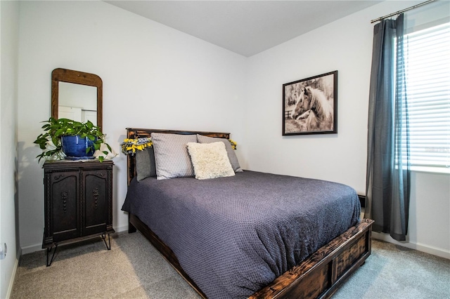 bedroom featuring baseboards and carpet flooring