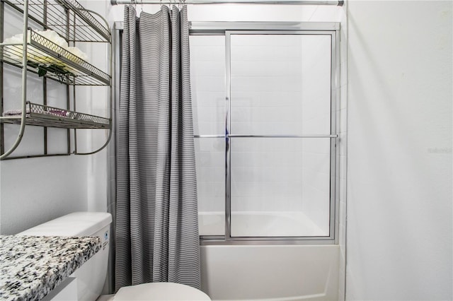 full bath featuring toilet and combined bath / shower with glass door