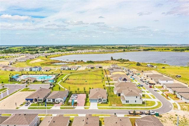 drone / aerial view featuring a residential view and a water view